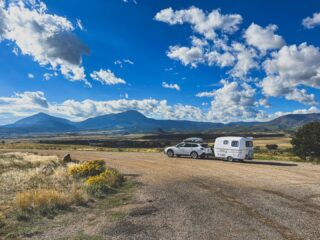 Some views are too good to drive past.
Ann W. captured this incredible moment with her Scamp, proving that the journey is just as rewarding as the destination. From wide-open skies to mountain views, it's the perfect reminder that adventure is always waiting around the next bend.
Thanks for sharing your travels with us, Ann! We love seeing where your Scamp takes you.
Have a favorite scenic stop from your travels? Share your photos in the comments, tag us, or send them to photos@scamptrailers.com—your adventure could be featured next!